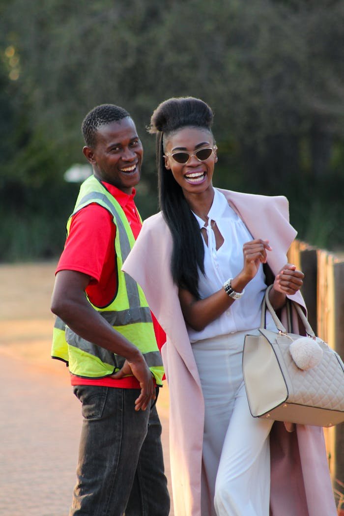 Two adults smiling outdoors in South Africa, capturing a moment of happiness and friendship.